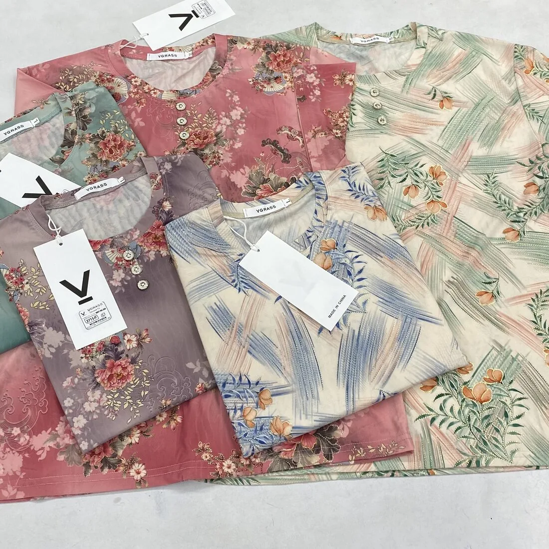 Women’s floral-print knit t-shirts laid flat with hangtags
